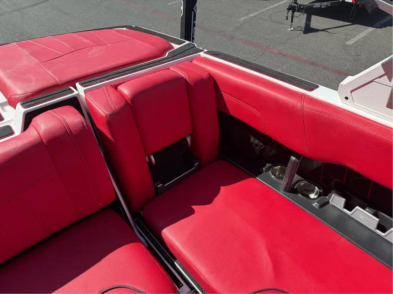 Slide: The Image of 2023 Malibu Wakesetter 23 MXZ interior with vibrant red seating and cup holders. - 16
