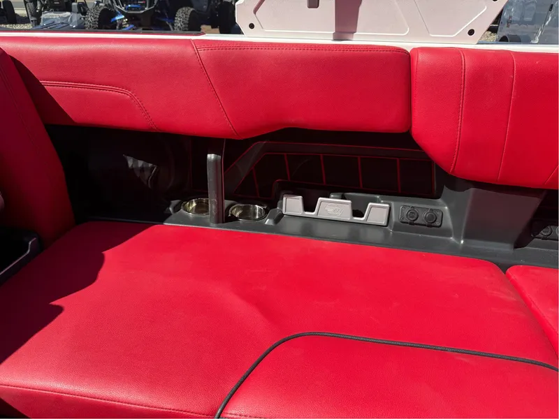 Slide: The Image of Red interior seating of 2023 Malibu Wakesetter 23 MXZ boat with cup holders. - 17