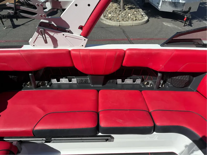 Slide: The Image of Red and black seating in 2023 Malibu Wakesetter 23 MXZ boat interior. - 19
