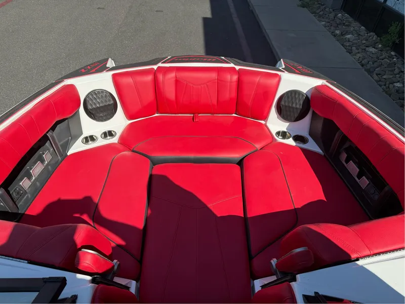 Slide: The Image of 2023 Malibu Wakesetter 23 MXZ boat with vibrant red seating and cup holders. - 22