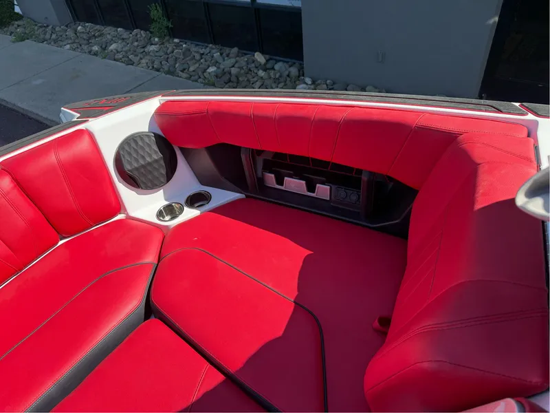 Slide: The Image of 2023 Malibu Wakesetter 23 MXZ interior with red seating and cup holders. - 25