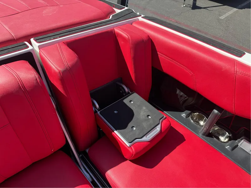 Slide: The Image of 2023 Malibu Wakesetter 23 MXZ interior with vibrant red seating and cup holders. - 28