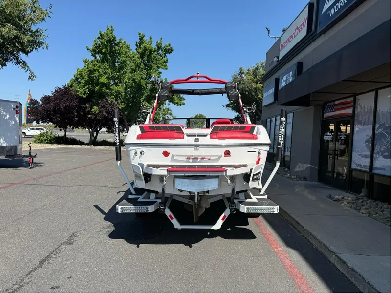Slide: The Image of 2023 Malibu Wakesetter 23 MXZ boat, rear view, parked outdoors near dealership. - 3