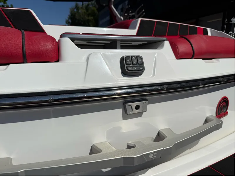Slide: The Image of 2023 Malibu Wakesetter 23 MXZ boat with red and black seating, rear view. - 35