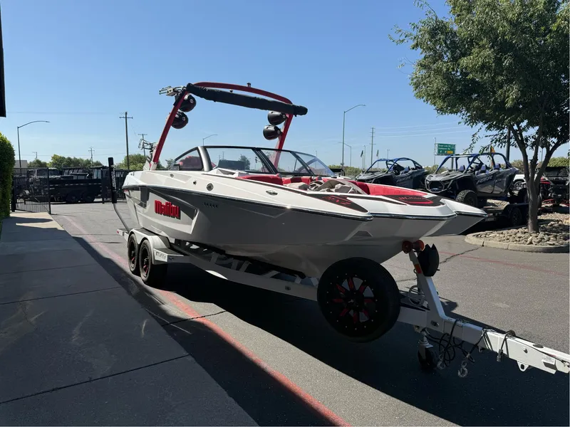 Slide: The Image of 2023 Malibu Wakesetter 23 MXZ boat on trailer, parked outdoors. - 5