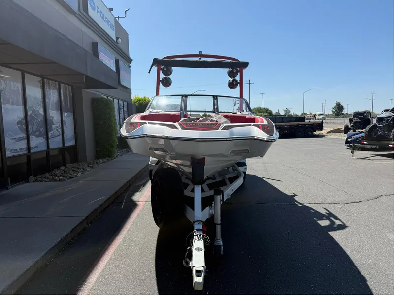 Slide: The Image of 2023 Malibu Wakesetter 23 MXZ boat on trailer, parked outdoors. - 6