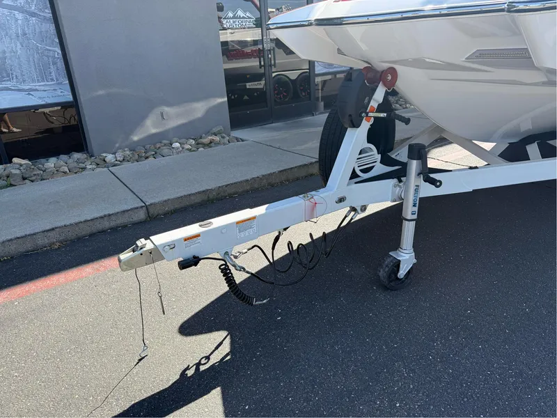 Slide: The Image of Trailer hitch of 2023 Malibu Wakesetter 23 MXZ boat on pavement. - 7