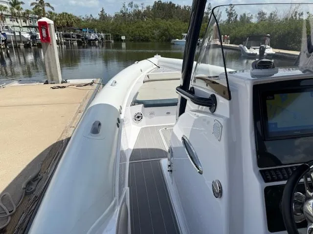 Slide: The Image of 2021 Airship 340 RIB boat docked at marina, featuring sleek design and modern controls. - 10