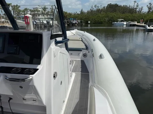 Slide: The Image of 2021 Airship 340 RIB boat docked in a serene marina setting. - 11