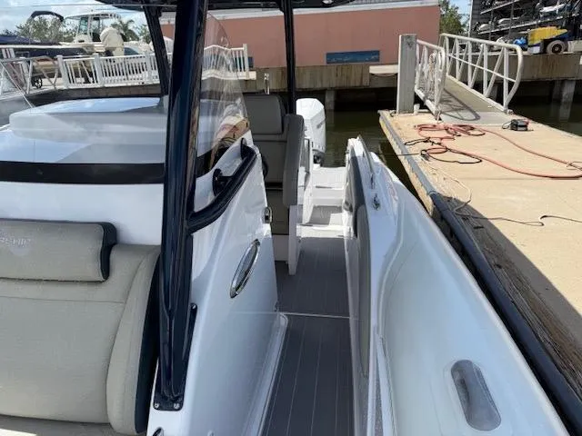 Slide: The Image of 2021 Airship 340 RIB boat docked, featuring sleek design and comfortable seating. - 14