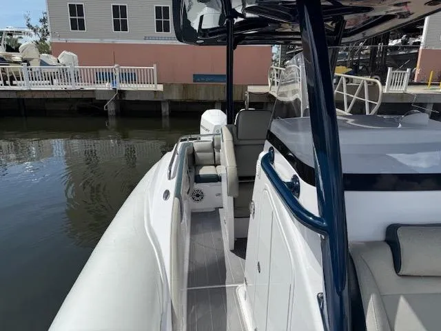 Slide: The Image of 2021 Airship 340 RIB boat docked, featuring sleek design and modern seating. - 15