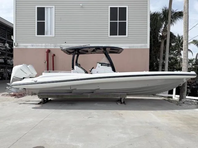 Slide: The Image of 2021 Airship 340 RIB boat on display outside a building. - 2