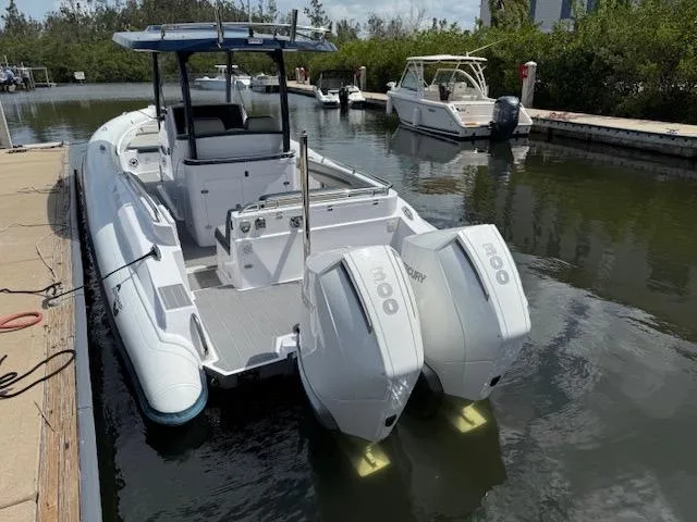 Slide: The Image of 2021 Airship 340 RIB boat docked with twin 300 horsepower engines. - 20
