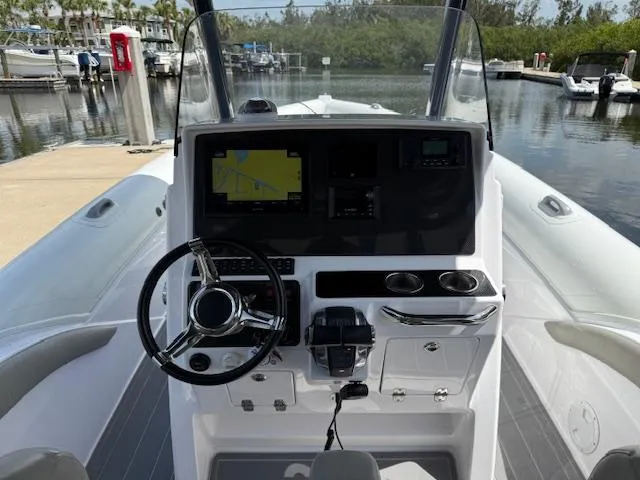 Slide: The Image of Cockpit view of 2021 Airship 340 RIB boat with steering wheel and navigation system. - 5