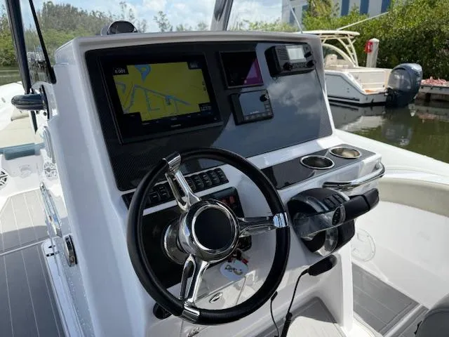 Slide: The Image of 2021 Airship 340 RIB boat dashboard with steering wheel and navigation display. - 6