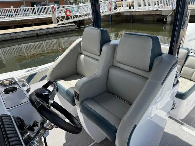 Slide: The Image of 2021 Airship 340 RIB boat interior with dual seats and steering wheel. - 8