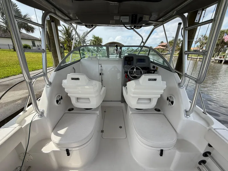 Slide: The Image of 2013 Robalo R245 Walkaround boat interior with dual seats and steering console. - 12