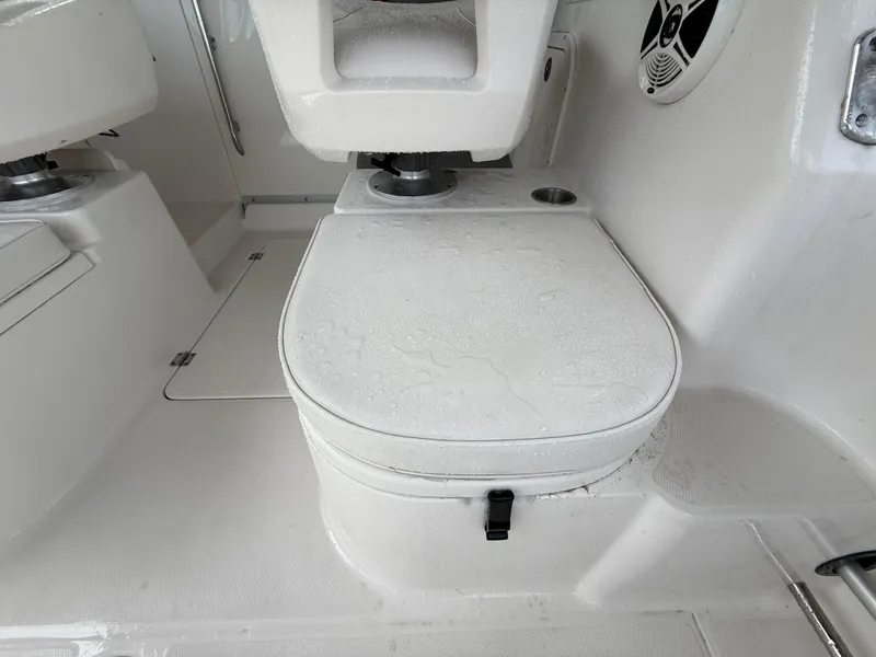Slide: The Image of 2013 Robalo R245 Walkaround boat interior with seating and speaker detail. - 14