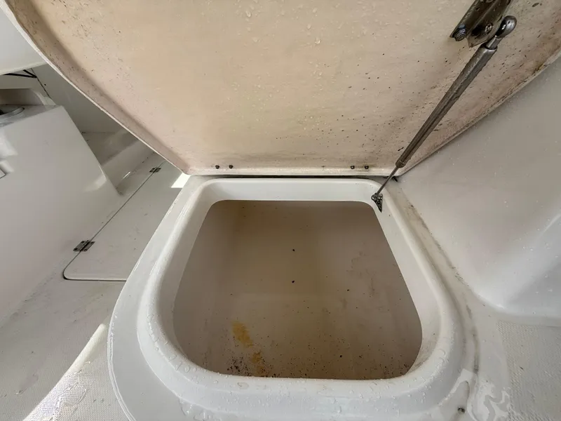 Slide: The Image of Open storage compartment on 2013 Robalo R245 Walkaround boat. - 15