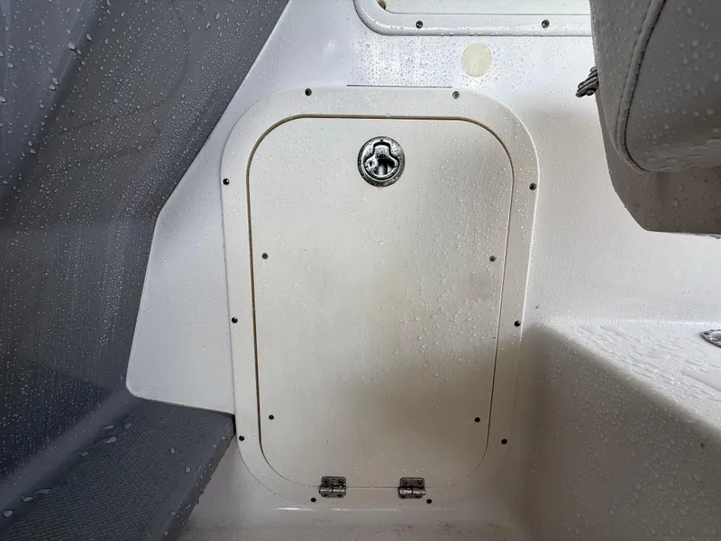 Slide: The Image of 2013 Robalo R245 Walkaround cabin interior with storage compartment door. - 22