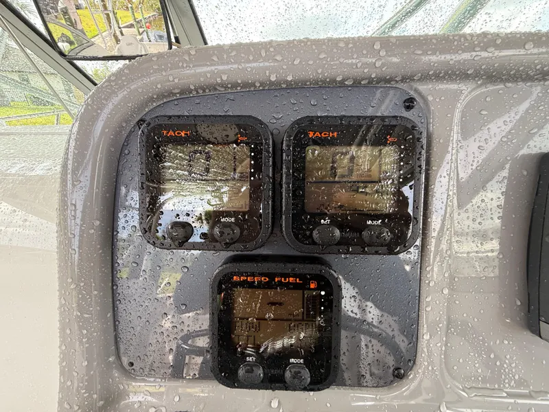 Slide: The Image of Dashboard of 2013 Robalo R245 Walkaround boat with raindrops on gauges. - 28