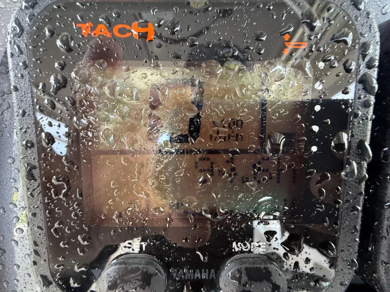 Slide: The Image of Close-up of a Yamaha tachometer on a 2013 Robalo R245 Walkaround, covered in water droplets. - 29