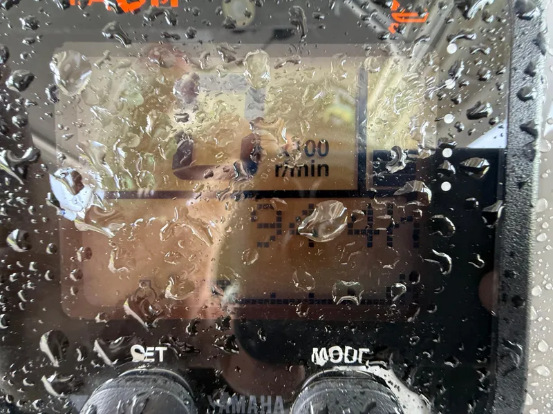 Slide: The Image of Close-up of a water-splashed Yamaha display on a 2013 Robalo R245 Walkaround boat. - 30