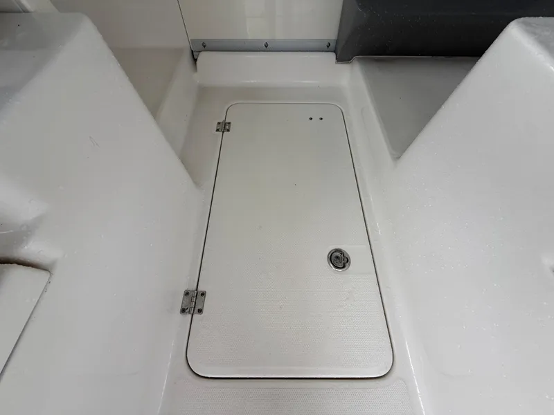 Slide: The Image of 2013 Robalo R245 Walkaround boat deck with storage hatch. - 34