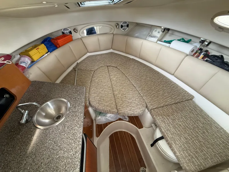 Slide: The Image of 2013 Robalo R245 Walkaround cabin interior with seating, sink, and storage. - 37