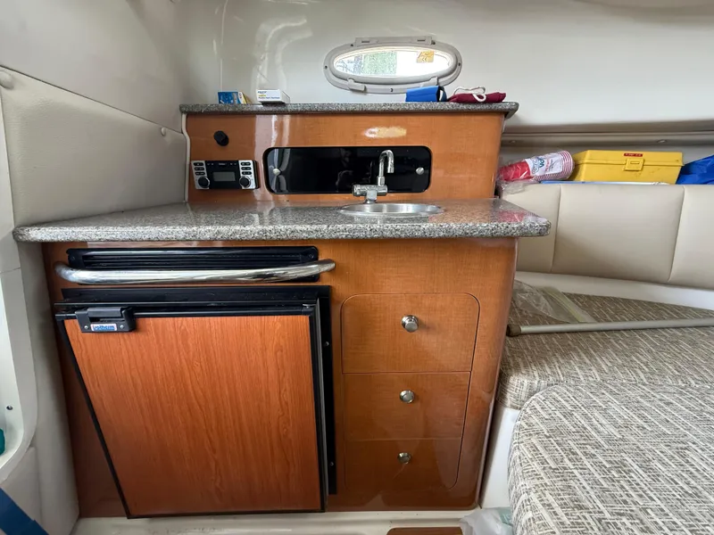 Slide: The Image of 2013 Robalo R245 Walkaround cabin with kitchenette, sink, and mini fridge. - 39