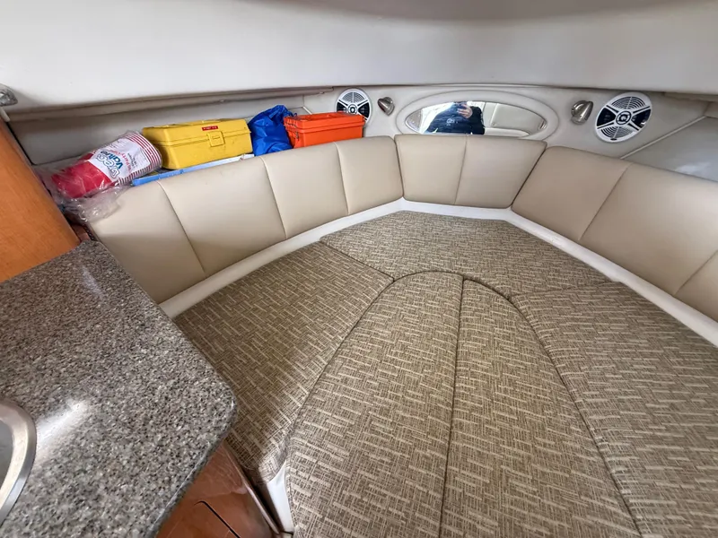 Slide: The Image of 2013 Robalo R245 Walkaround cabin interior with cushioned seating and storage. - 40