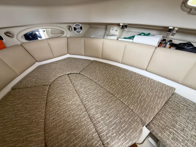 Slide: The Image of 2013 Robalo R245 Walkaround cabin interior with beige seating and storage compartments. - 41