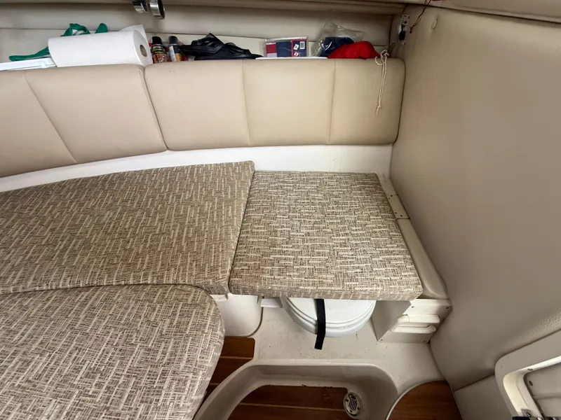 Slide: The Image of 2013 Robalo R245 Walkaround cabin interior with cushioned seating and storage. - 42