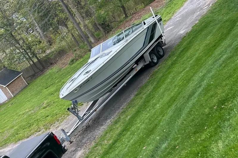 Slide: The Image of 1987 Formula 272 SR-1 boat on trailer, parked on a grassy driveway. - 2