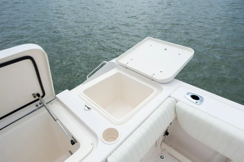 Slide: The Image of 2011 Grady-White Canyon 366 boat deck with open storage compartments, near water. - 10