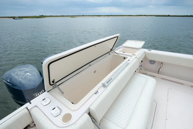 Slide: The Image of 2011 Grady-White Canyon 366 boat with open storage compartment on calm water. - 11