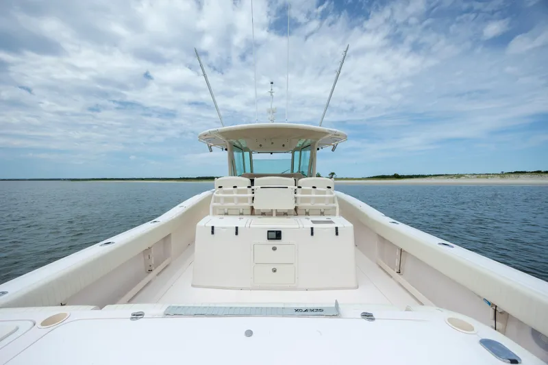 Slide: The Image of 2011 Grady-White Canyon 366 boat on calm water under a partly cloudy sky. - 14