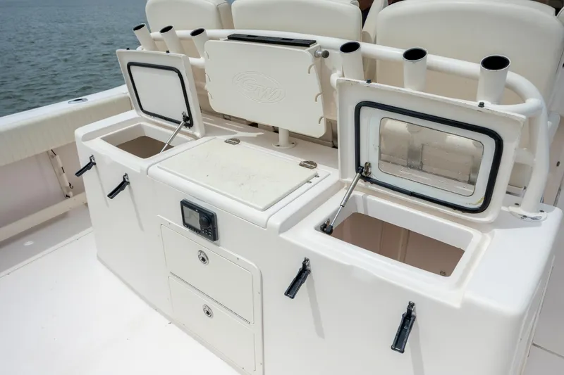 Slide: The Image of 2011 Grady-White Canyon 366 boat deck with storage compartments and rod holders. - 16