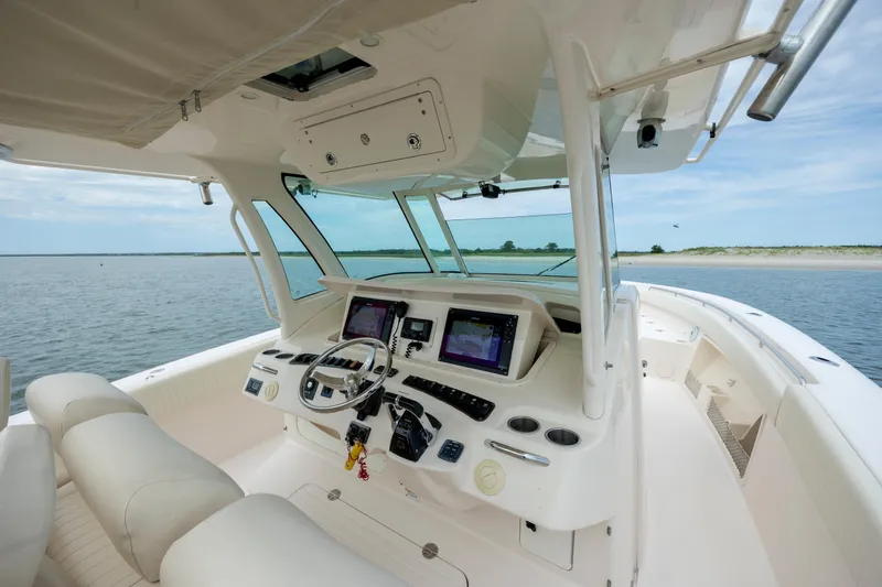 Slide: The Image of 2011 Grady-White Canyon 366 boat interior with modern navigation equipment and ocean view. - 18