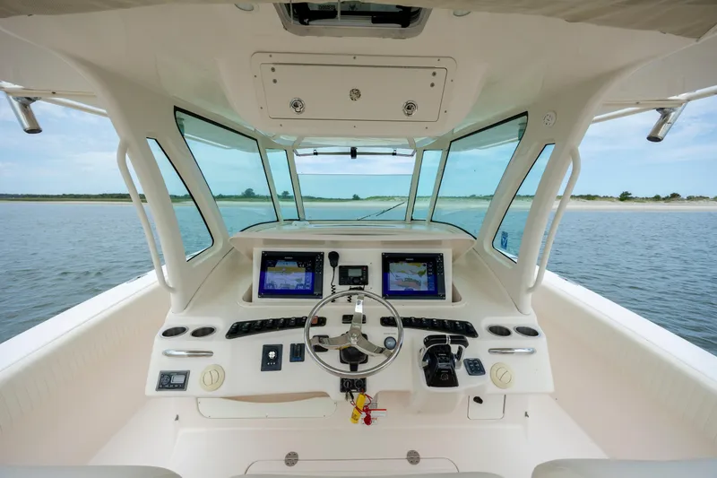 Slide: The Image of Helm of 2011 Grady-White Canyon 366 boat with dual navigation screens. - 19
