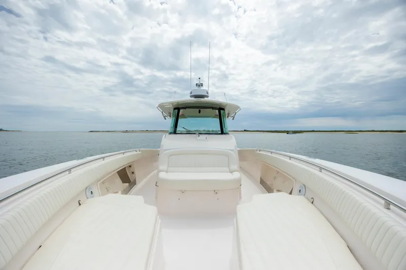 Slide: The Image of 2011 Grady-White Canyon 366 boat on calm water under cloudy sky. - 23