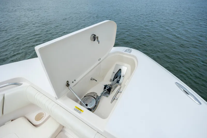 Slide: The Image of 2011 Grady-White Canyon 366 boat anchor compartment open on calm water. - 27