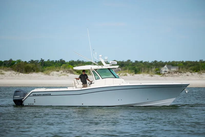 Slide: The Image of 2011 Grady-White Canyon 366 boat on water near sandy shoreline. - 4