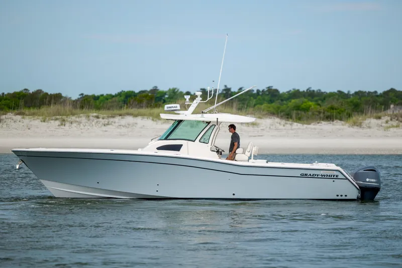 Slide: The Image of 2011 Grady-White Canyon 366 boat on water near sandy shoreline. - 6