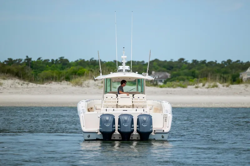 Slide: The Image of 2011 Grady-White Canyon 366 boat on water near sandy beach. - 7