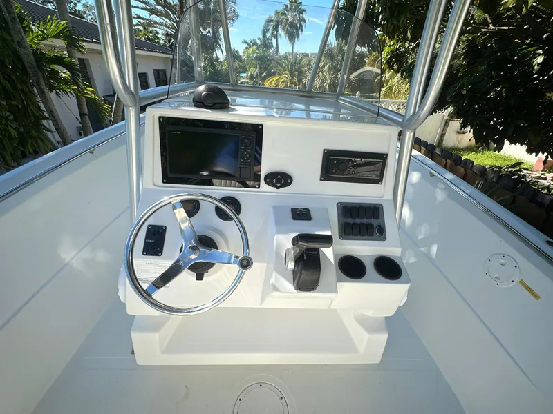 Slide: The Image of 2005 Sailfish 2360 CC boat console with steering wheel and navigation equipment. - 11