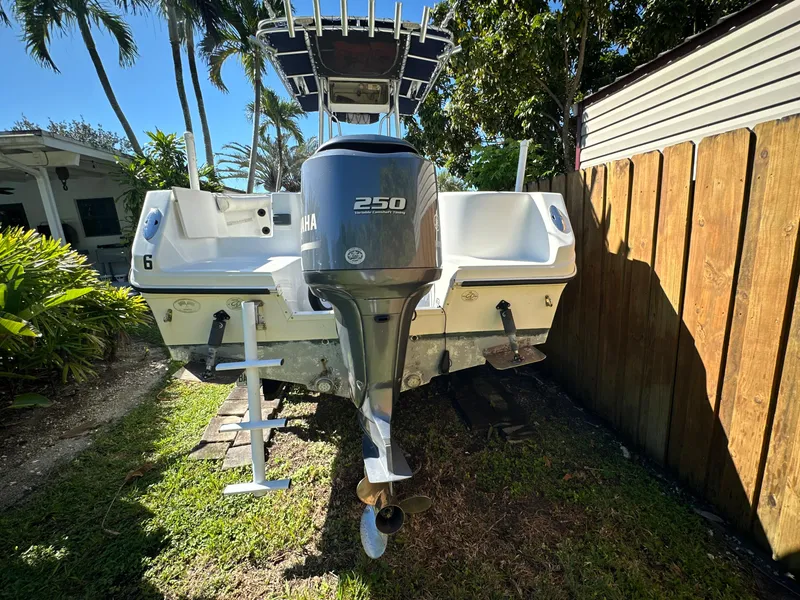 Slide: The Image of 2005 Sailfish 2360 CC boat with Yamaha 250 outboard motor, parked outdoors. - 4