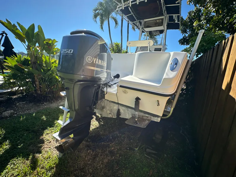 Slide: The Image of 2005 Sailfish 2360 CC boat with Yamaha 250 engine, parked outdoors. - 5