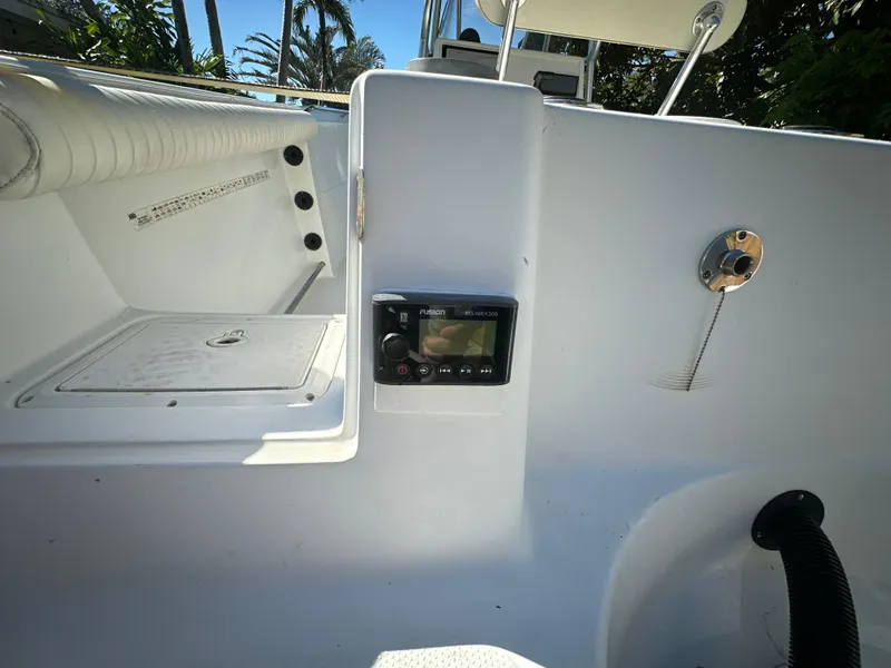 Slide: The Image of 2005 Sailfish 2360 CC boat interior with control panel and seating area. - 6
