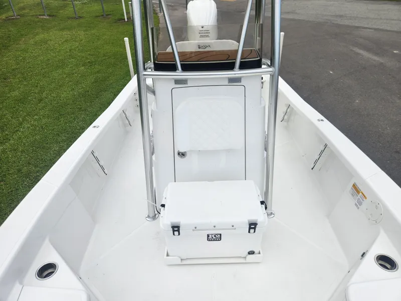 Slide: The Image of 2025 BlackJack 256 Bay boat deck with cooler and storage compartment. - 13